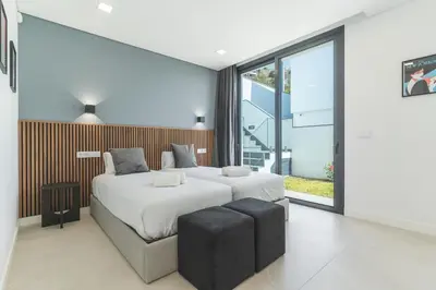 a bedroom with a large bed and a large window at Villa Devaneio - Amazing Ocean View by Atlantic Holiday in Ribeira Brava
