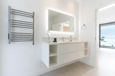 a white bathroom with a sink and a mirror at Villa Devaneio - Amazing Ocean View by Atlantic Holiday in Ribeira Brava