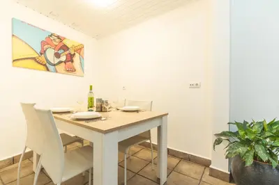a dining room with a table and chairs at A Casinha by Atlantic Holiday in Câmara de Lobos
