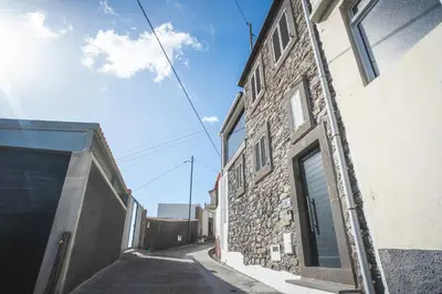 an alley with a stone building with a door at A Casinha by Atlantic Holiday in Câmara de Lobos