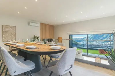 a dining room with a table and chairs and a window at Villa Sofia by Atlantic Holiday in Machico