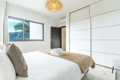 a bedroom with a large white bed with a window at Villa Sofia by Atlantic Holiday in Machico