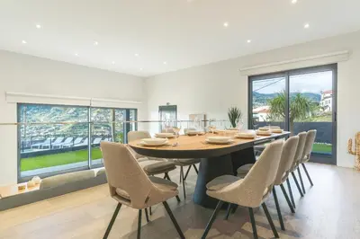 a dining room with a large table and chairs at Villa Sofia by Atlantic Holiday in Machico