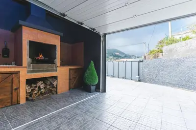 a living room with a fireplace in a house at Villa Sofia by Atlantic Holiday in Machico