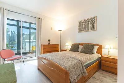 a bedroom with a bed and a large window at Richelieu Apartment by Atlantic Holiday in Água de Pena