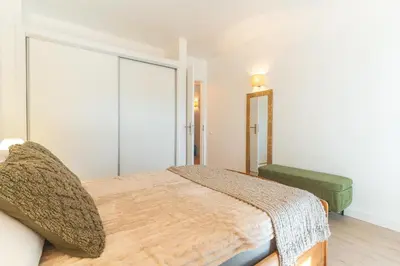 a bedroom with a bed and a large window at Richelieu Apartment by Atlantic Holiday in Água de Pena
