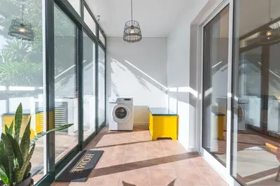 a hallway with a washing machine in a building at Richelieu Apartment by Atlantic Holiday in Água de Pena