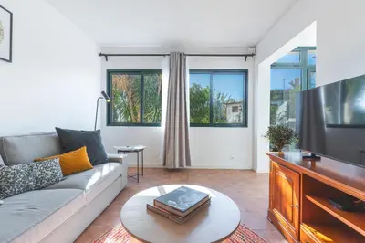 a living room with a couch and a tv at Richelieu Apartment by Atlantic Holiday in Água de Pena