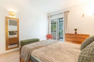 a bedroom with a bed and a mirror at Richelieu Apartment by Atlantic Holiday in Água de Pena
