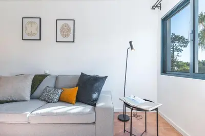 a living room with a couch and a table at Richelieu Apartment by Atlantic Holiday in Água de Pena
