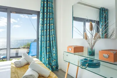 a room with a desk and a window with a view at Aqui ha Casa - Ocean View by Atlantic Holiday in Gaula
