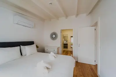 a bedroom with two beds with white sheets at Casa da Levada in Funchal