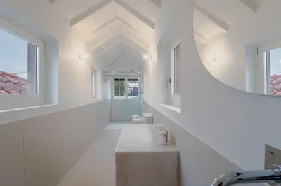 a hallway of a house with a sink and a mirror at Casa da Levada in Funchal