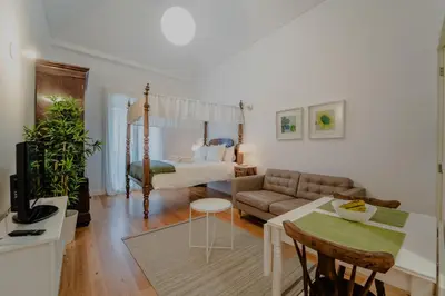 a living room with a bed and a couch at Casa da Levada in Funchal