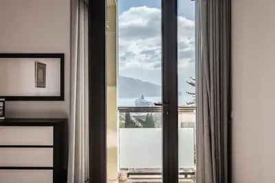 a room with a window with a view of a ship at Sea View 1 Bedroom Apartment Funchal in Funchal