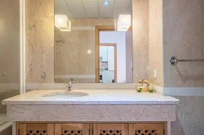 a bathroom with a sink and a large mirror at Sea View 1 Bedroom Apartment Funchal in Funchal