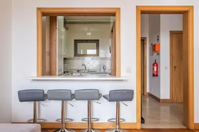 a kitchen with a mirror and four bar stools at Sea View 1 Bedroom Apartment Funchal in Funchal