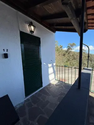 a door on the side of a building with a fence at Habitación con Cocina en la Montaña in Funchal
