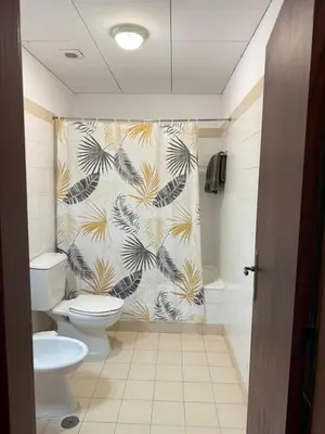 a bathroom with a toilet and a shower curtain at Habitación con Cocina en la Montaña in Funchal