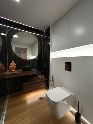 a bathroom with a white toilet and a mirror at Luxury Apartament NEXT to SAVOY in Funchal
