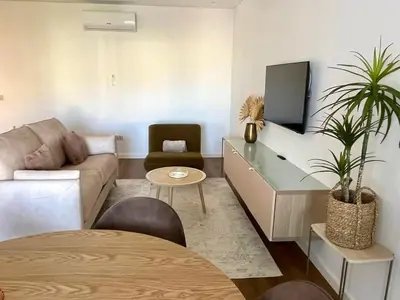 a living room with a couch and a tv at Luxury Apartament NEXT to SAVOY in Funchal