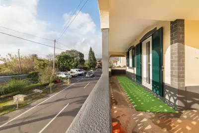 a view from a balcony of a house with green grass at Abrigo dos Prazeres Guesthouse by Mth in Prazeres