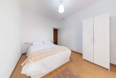a white bedroom with a bed and a closet at Abrigo dos Prazeres Guesthouse by Mth in Prazeres