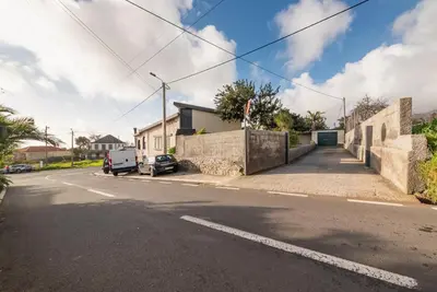 an empty street with a house and a car at Abrigo dos Prazeres Guesthouse by Mth in Prazeres