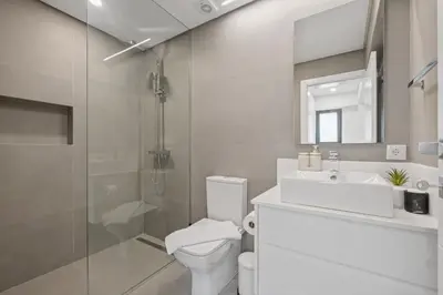 a bathroom with a toilet and a sink and a shower at Central Apartment Steps From Beach in Ponta do Sol