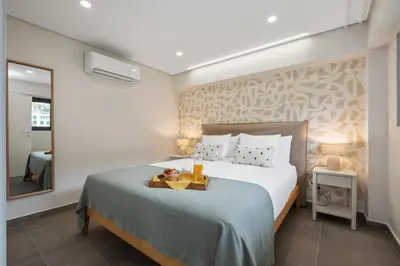 a bedroom with a bed with a tray on it at Central Apartment Steps From Beach in Ponta do Sol