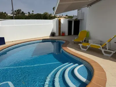 a swimming pool in the middle of a house at Casa Bella - a charming holiday house in Luz in Luz