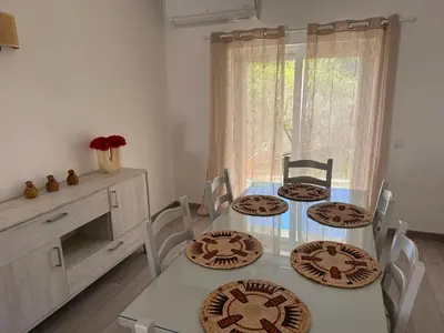 a dining room with a table with four plates on it at Casa Bella - a charming holiday house in Luz in Luz