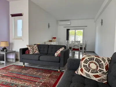 a living room with a couch and a table at Casa Bella - a charming holiday house in Luz in Luz