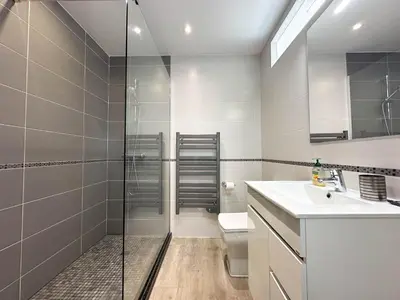 a bathroom with a shower and a toilet and a sink at Casa Bella - a charming holiday house in Luz in Luz