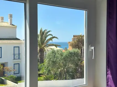 a window with a view of the ocean at Casa Bella - a charming holiday house in Luz in Luz