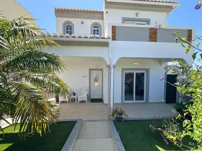 a white house with a patio and a yard at Casa Bella - a charming holiday house in Luz in Luz