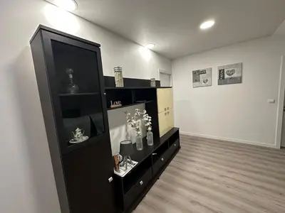 a living room with a black entertainment center at Cantinho dos Sonhos in Santa Cruz