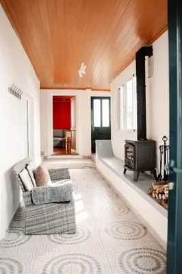 a living room with a fireplace and a couch and a stove at Madeira Island Rustic Mountain Home in Estreito de Câmara de Lobos