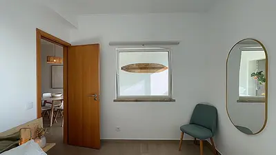 a room with a mirror and a chair and a window at Ocaso - Aljezur sea view stunning sunsets Arrifana in Aljezur