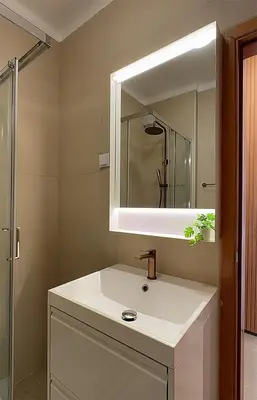 a bathroom with a white sink and a mirror at Ocaso - Aljezur sea view stunning sunsets Arrifana in Aljezur