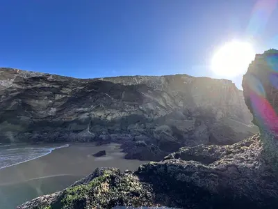 a view of a beach with the sun and the ocean at Ocaso - Aljezur sea view stunning sunsets Arrifana in Aljezur