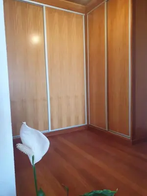 a white flower in a room with wooden cabinets at Farol Golfe in Ponta do Pargo