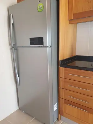a white refrigerator in a kitchen next to a counter at Farol Golfe in Ponta do Pargo