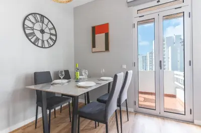 a dining room with a table and chairs and a clock at Lido Edge View - Ocean View by Atlantic View in Funchal
