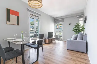 a dining room and living room with a table and chairs at Lido Edge View - Ocean View by Atlantic View in Funchal