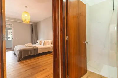 a bedroom with a bed and a sliding glass door at Lido Edge View - Ocean View by Atlantic View in Funchal
