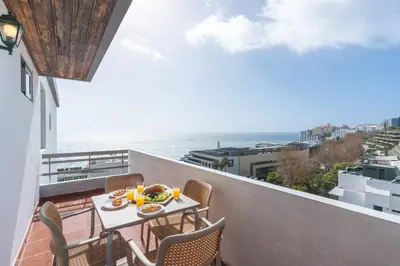 a balcony with a table and chairs and the ocean at Lido Edge View - Ocean View by Atlantic View in Funchal