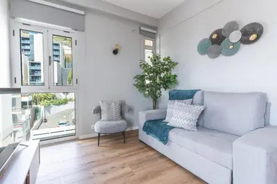 a living room with a couch and a chair at Lido Edge View - Ocean View by Atlantic View in Funchal