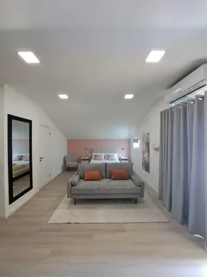 a living room with two beds in a room at Estudio Vista Mar in Ribeira Brava