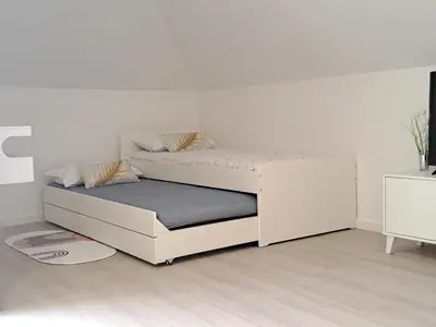 a white bedroom with a bed and a white wall at Estudio Vista Mar in Ribeira Brava